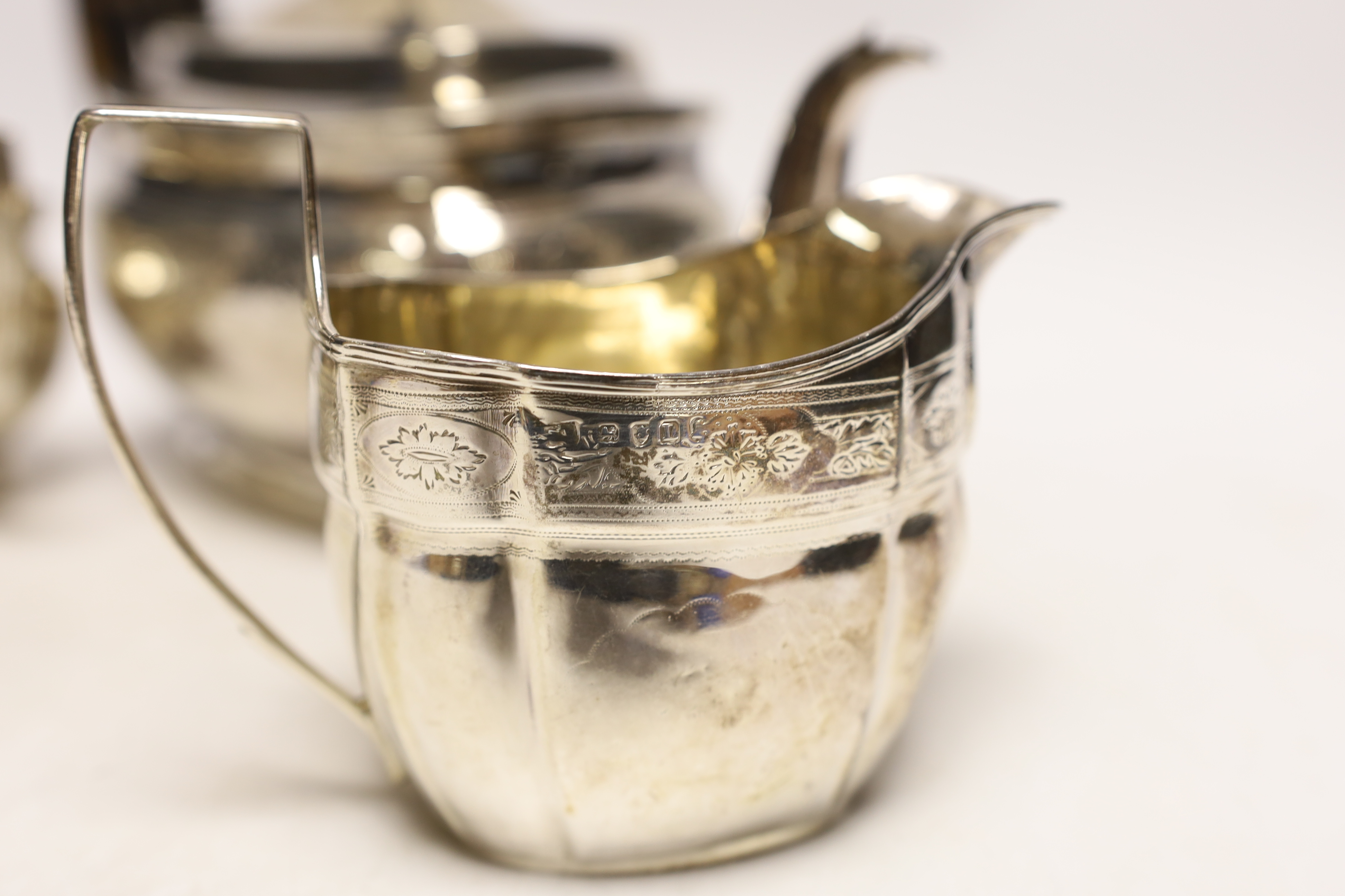 A George III engraved silver teapot and sugar bowl, by Andrew Fogelberg, London, 1805 and a similar matched silver cream jug, maker's mark rubbed, London, 1806